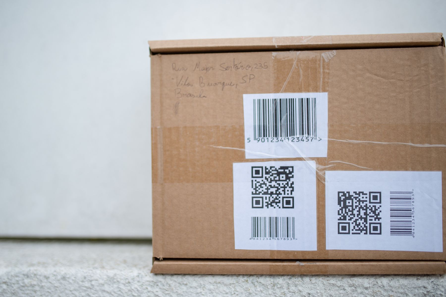 Package label with QR code and barcode