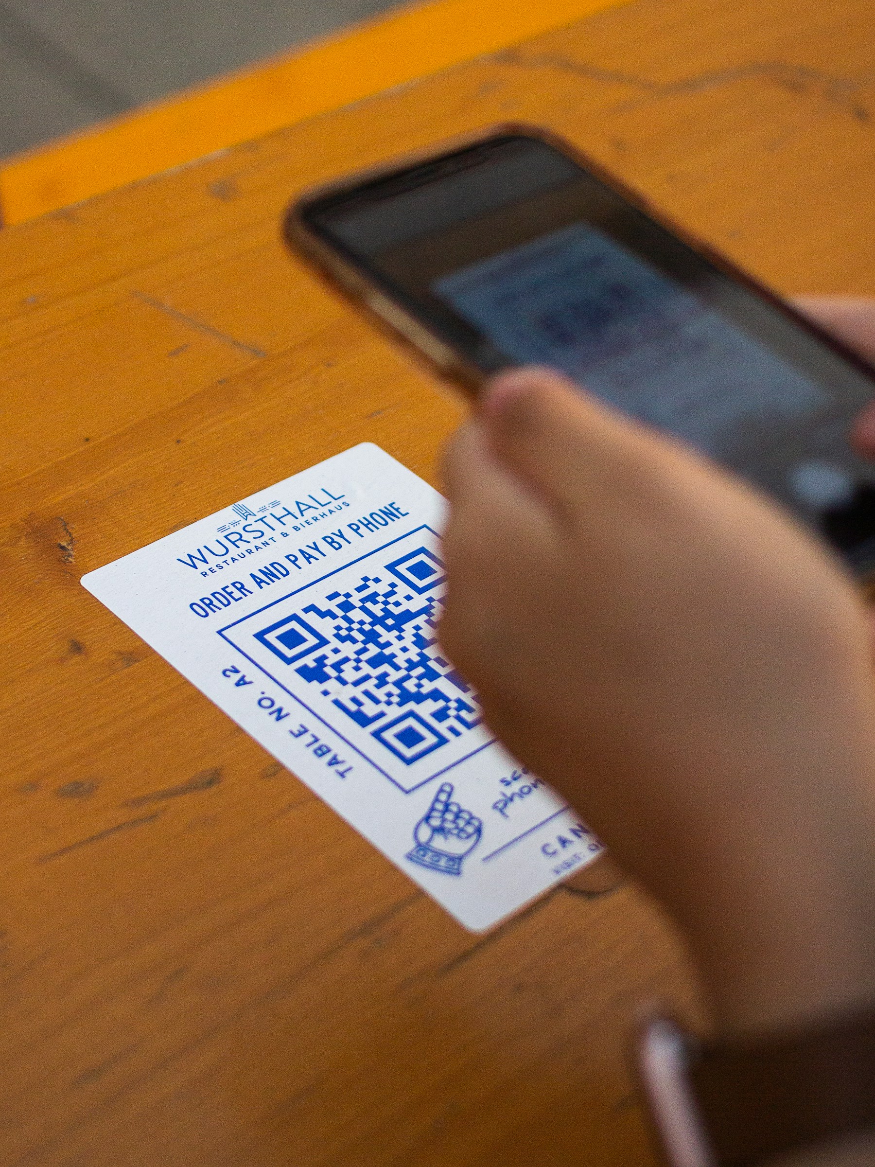 Customer holding a restaurant QR code card